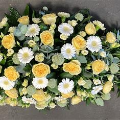 Yellow and white casket spray